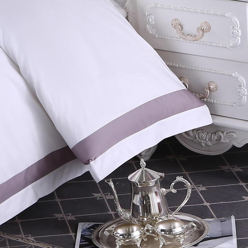 Commercial washing machines processing white hotel linens